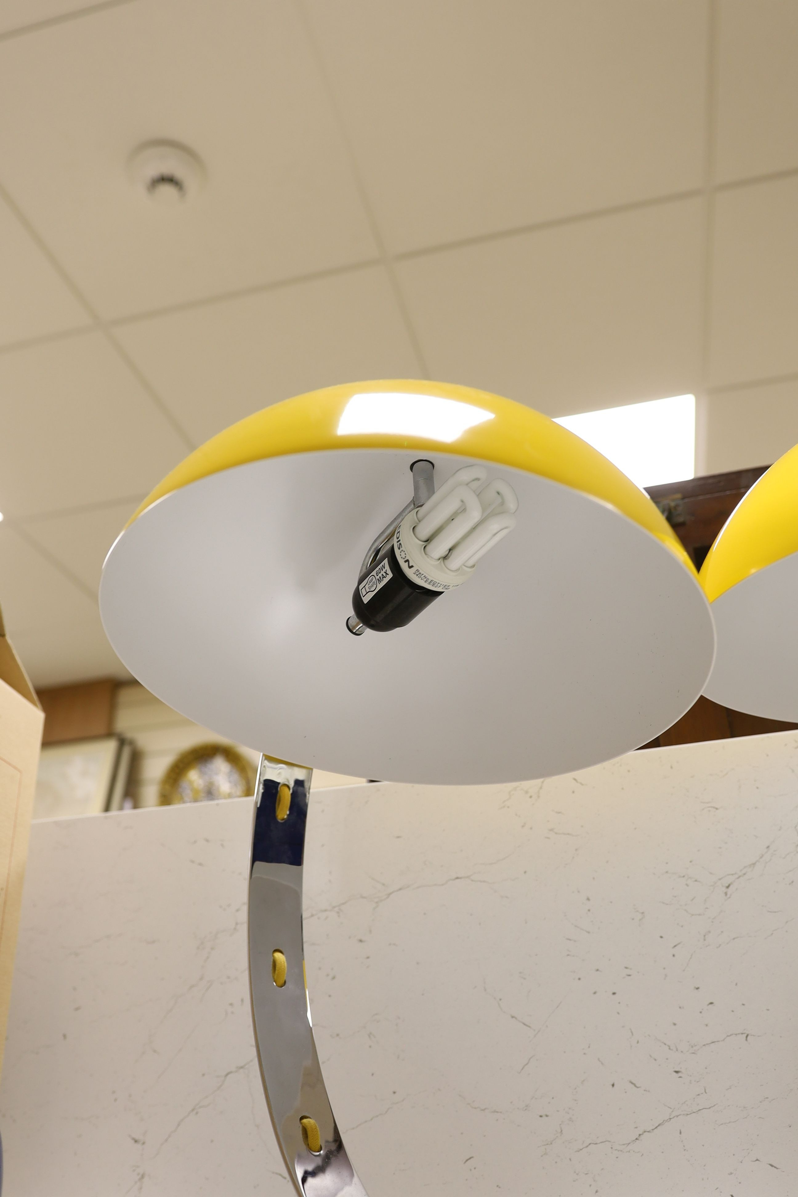 A pair of contemporary chrome reading lamps with yellow glass domed shades, 46 cms high.